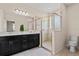 Bathroom features double vanity, glass enclosed shower, tile flooring, and modern fixtures at 14500 Black Quill Dr, Winter Garden, FL 34787