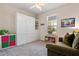 Cozy bedroom with carpet, built-ins, sofabed, natural light, and colorful decor at 14500 Black Quill Dr, Winter Garden, FL 34787