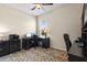 Carpeted home office featuring patterned rug, dual monitors, ample storage, and bright lighting at 14500 Black Quill Dr, Winter Garden, FL 34787