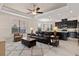 Comfortable living room offering neutral color tones, dark furniture, a ceiling fan and lots of natural light at 14500 Black Quill Dr, Winter Garden, FL 34787