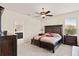 Main bedroom featuring a ceiling fan, king bed and a connecting bathroom at 14500 Black Quill Dr, Winter Garden, FL 34787