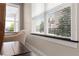 Sitting area featuring a comfortable chair and window with wooded views at 14500 Black Quill Dr, Winter Garden, FL 34787