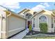 Inviting one-story home featuring a beige exterior, and a well-maintained lawn at 1600 Riveredge Rd, Oviedo, FL 32766