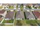 An aerial view showcases the home's roof, backyard, and proximity to neighboring houses at 16140 Yelloweyed Dr, Clermont, FL 34714