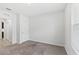 Simple bedroom with plush carpet, a window, and neutral paint at 16140 Yelloweyed Dr, Clermont, FL 34714