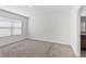 Neutral bedroom with carpet flooring, a window for natural light, and a closet at 16140 Yelloweyed Dr, Clermont, FL 34714