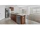 Bright kitchen with stainless steel appliances, tile flooring, and a view of the living area at 16140 Yelloweyed Dr, Clermont, FL 34714