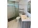Bright bathroom featuring a tiled shower with pebble floor, toilet, and vanity with white countertop at 1623 Bridgeview Cir, Orlando, FL 32824