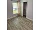 Bedroom showcasing wood-look floors, window with blinds, and closet with open door at 1623 Bridgeview Cir, Orlando, FL 32824