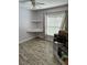Bedroom featuring built-in shelves, a window, wood-look floor, and moving boxes at 1623 Bridgeview Cir, Orlando, FL 32824