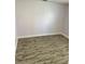Empty bedroom featuring modern wood-look flooring and neutral walls at 1623 Bridgeview Cir, Orlando, FL 32824