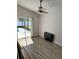 Bright bedroom with hardwood floors, and sliding glass doors leading to the pool area at 1623 Bridgeview Cir, Orlando, FL 32824