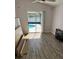 Bright bedroom with hardwood floors, and sliding glass doors leading to the pool area at 1623 Bridgeview Cir, Orlando, FL 32824