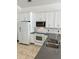 Close up of a bright kitchen with white cabinets, granite countertops, and stainless steel appliances at 1623 Bridgeview Cir, Orlando, FL 32824