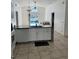 Spacious kitchen featuring white cabinets and an island with views to the pool and outdoor space at 1623 Bridgeview Cir, Orlando, FL 32824