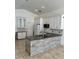 Bright kitchen with white cabinets, granite countertops, stainless steel appliances, and a stone island at 1623 Bridgeview Cir, Orlando, FL 32824