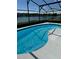 Relaxing pool with serene lake view under a screened enclosure, offering a perfect outdoor retreat at 1623 Bridgeview Cir, Orlando, FL 32824