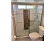 A tiled shower with glass doors and bronze accents at 1623 Bridgeview Cir, Orlando, FL 32824