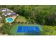 Aerial view of the community pool, tennis court, and surrounding green space at 1669 Slash Pine Pl, Oviedo, FL 32765