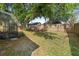 Large backyard showcasing a fenced-in yard with mature trees, offering ample space for outdoor activities at 1669 Slash Pine Pl, Oviedo, FL 32765