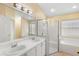 Bright bathroom features double sink vanity, shower, soaking tub, and a window providing natural light at 1669 Slash Pine Pl, Oviedo, FL 32765