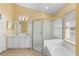 Bright bathroom features double sink vanity, soaking tub, glass shower, and a window providing natural light at 1669 Slash Pine Pl, Oviedo, FL 32765