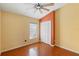 Bright bedroom features wood floors, ceiling fan, closet and a window providing natural light at 1669 Slash Pine Pl, Oviedo, FL 32765