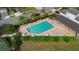 Aerial view featuring the community pool with sun loungers and manicured landscaping for relaxing outdoor enjoyment at 1669 Slash Pine Pl, Oviedo, FL 32765
