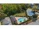 Aerial view showcasing a community pool, tennis court, and ample green space for recreation and leisure at 1669 Slash Pine Pl, Oviedo, FL 32765