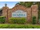 Community entrance sign for Dunhill, surrounded by lush landscaping at 1669 Slash Pine Pl, Oviedo, FL 32765