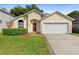 Charming single-Gathering home with a well-maintained lawn, beautiful shrubs, and a two-car garage at 1669 Slash Pine Pl, Oviedo, FL 32765