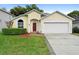 Charming single-story home with a well-manicured lawn and a two-car garage at 1669 Slash Pine Pl, Oviedo, FL 32765
