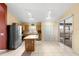 Open kitchen with island, stainless steel appliances, and closet pantry at 1669 Slash Pine Pl, Oviedo, FL 32765