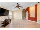 Spacious living room with tile floors, a ceiling fan, and ample natural light at 1669 Slash Pine Pl, Oviedo, FL 32765