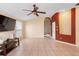 Spacious living room with tile floors, a ceiling fan, and ample natural light at 1669 Slash Pine Pl, Oviedo, FL 32765