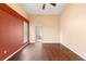 Spacious main bedroom features wood floors, a ceiling fan, a window and ensuite bathroom access at 1669 Slash Pine Pl, Oviedo, FL 32765