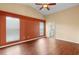 Spacious main bedroom features wood floors, a ceiling fan, two windows and ensuite bathroom access at 1669 Slash Pine Pl, Oviedo, FL 32765