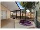 Screened patio featuring a relaxing in-ground hot tub and a ceiling fan for comfortable outdoor enjoyment at 1669 Slash Pine Pl, Oviedo, FL 32765