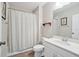 Well-lit bathroom featuring shower, quartz countertops, framed art, and a decorative shelf at 1848 Napoli Dr, St Cloud, FL 34771