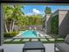 Beautiful backyard featuring a pool, outdoor kitchen, lush landscaping, and privacy fence at 1970 Laurel Rd, Winter Park, FL 32789