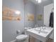Contemporary powder room with a large sink, toilet, and stylish decor at 1970 Laurel Rd, Winter Park, FL 32789