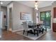 View of a cozy dining area with an elongated wood table and decorative wall art at 1970 Laurel Rd, Winter Park, FL 32789