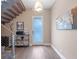 Inviting home entryway featuring hardwood floors, modern light fixtures, and an open staircase at 1970 Laurel Rd, Winter Park, FL 32789