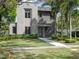 Striking modern home with well-maintained lawn, lush landscaping, and a stylish gray facade at 1970 Laurel Rd, Winter Park, FL 32789