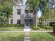 Contemporary home with a manicured lawn, trimmed hedges, and tall palm trees enhancing curb appeal at 1970 Laurel Rd, Winter Park, FL 32789