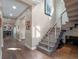 Hallway with modern staircase, wooden floors, and access to multiple rooms at 1970 Laurel Rd, Winter Park, FL 32789