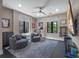Bright home gym featuring comfortable gray seating, exercise equipment, and multiple windows at 1970 Laurel Rd, Winter Park, FL 32789