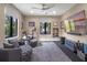 Bright home gym features comfortable gray seating, wall-mounted TV, stationary bike, and views to the outside at 1970 Laurel Rd, Winter Park, FL 32789