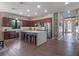 Open kitchen featuring a large island, modern appliances, hardwood floors and dark wood cabinetry at 1970 Laurel Rd, Winter Park, FL 32789