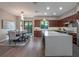 Open kitchen with a large island, modern cabinets, hardwood floors and an adjacent dining area at 1970 Laurel Rd, Winter Park, FL 32789